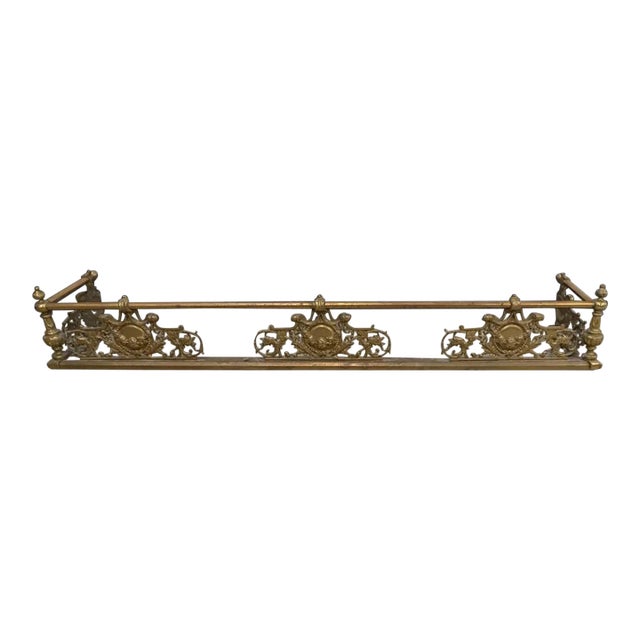 An Early 20th Century Renaissance Revival Style Solid Brass Fire Fender Measures 49" in width, 9.25" in depth and 7.25" in...