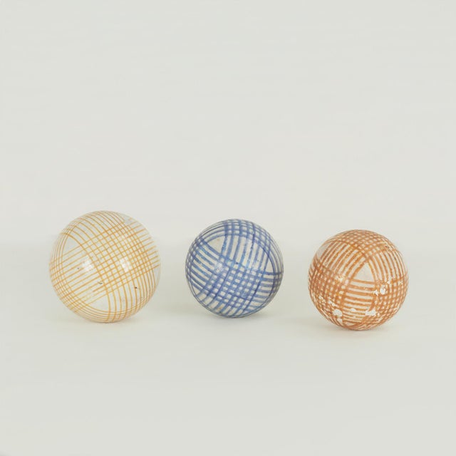 Unlikely collection of ten ceramic lawn ball of various sizes and decorations.