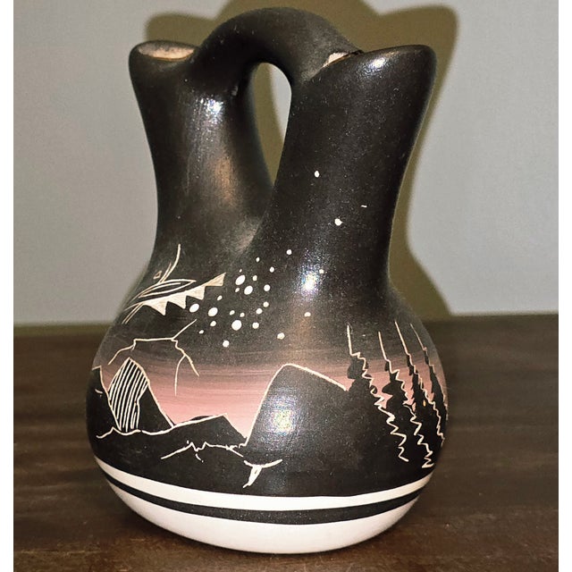 A striking 1987 hand‑painted wedding vase from Hozoni Pottery, decorated by Native American studio artists and signed...