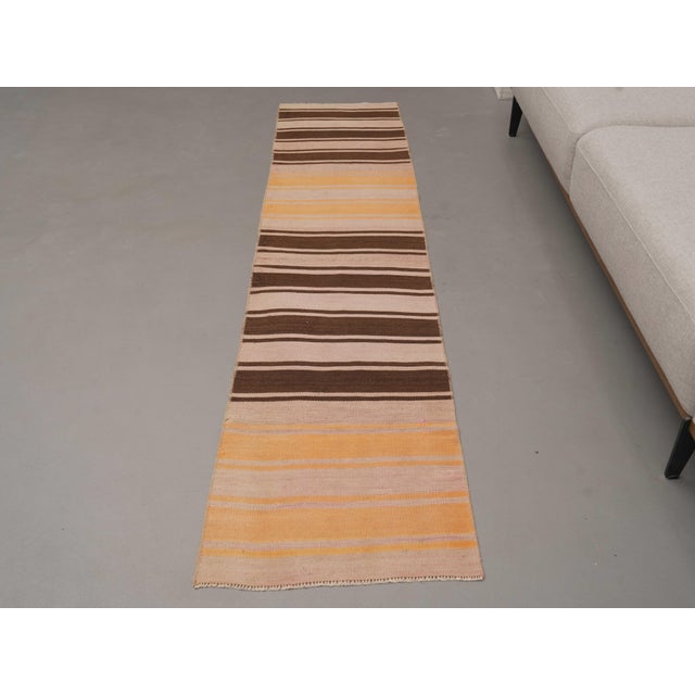 Vintage Hand-Knotted runner rug is a semi-antique vintage area rug. The '70s Eastern region of Anatolia's unique rug is...