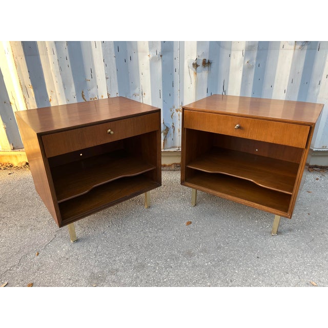 A Pair of Vintage Mid Century Modern Nightstands by John Stuart. Circa 1960s Feature a sleek Mid Century Modern Design...