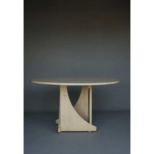 A 1970s hand built circular pine dining table. Possibly a prototype or a personal project. Made out of one sheet of solid...