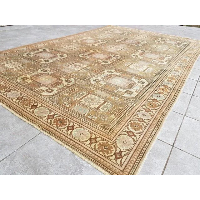 This is a vintage Turkish Oushak rug from the 1960s. The piece was hand-knotted