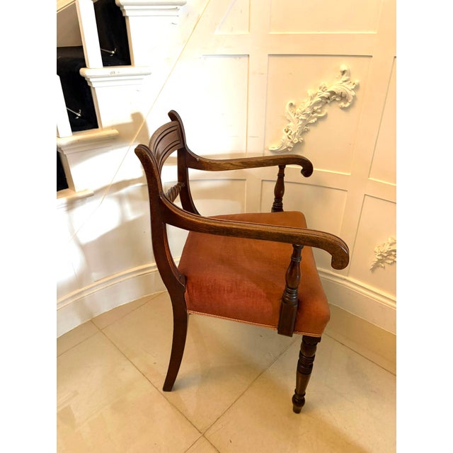 A superb antique Regency mahogany open armchair of elegant proportions, raised on turned front legs with splayed rear...