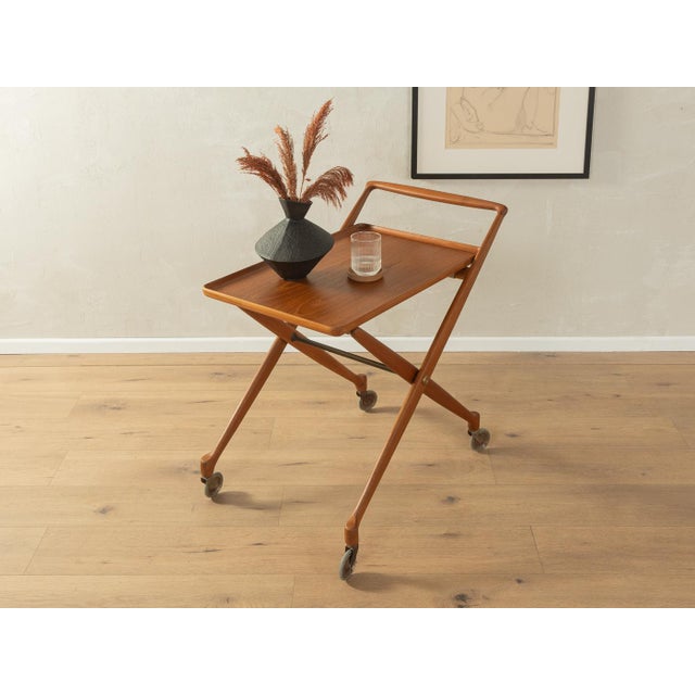 Classic serving trolley from the 1960s by K. Knudsen & Son. Folding teak frame with a removable teak veneer tray and metal...