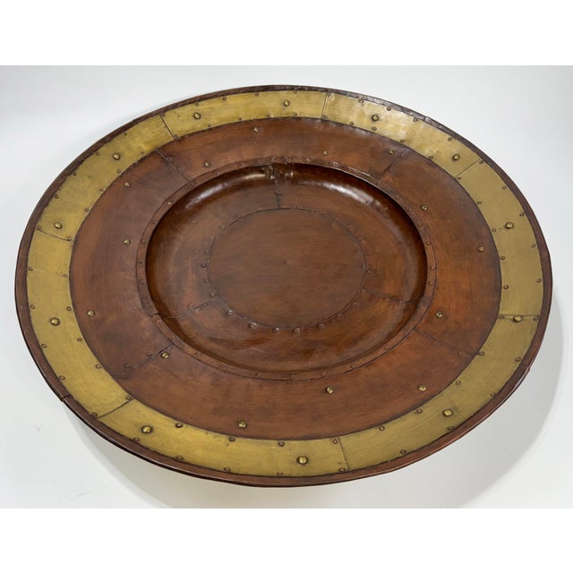 Substantial vintage Industrial style riveted metal tray. Copper and brass tones. Hook for hanging if desired. Age wear.