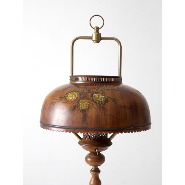 A distinctive vintage floor lamp combining rustic charm with decorative sophistication. The turned wood column rises from...