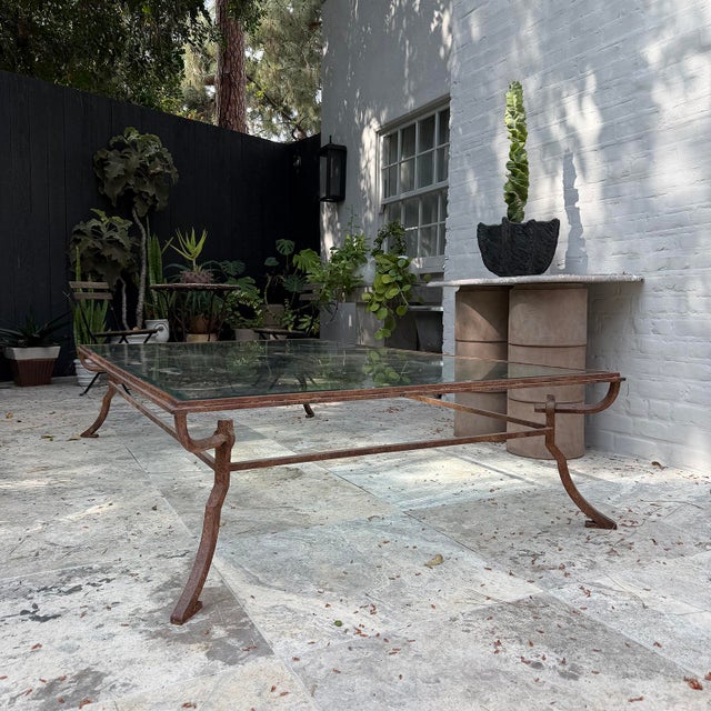20th century bronze and beveled glass table in the style of Giacometti. Suitable for outdoor use.