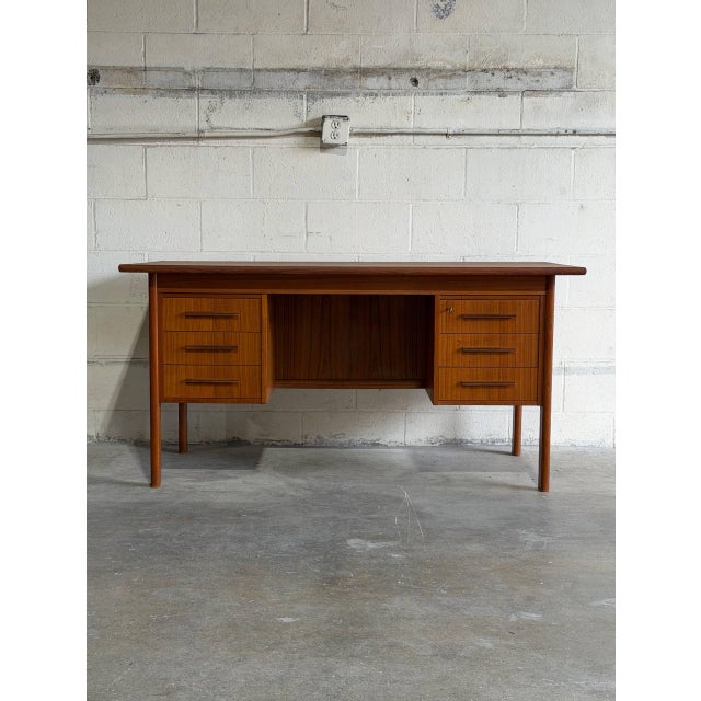 This vintage freestanding office workstation features an expansive rectangular top paired with dual drawer pedestals for...