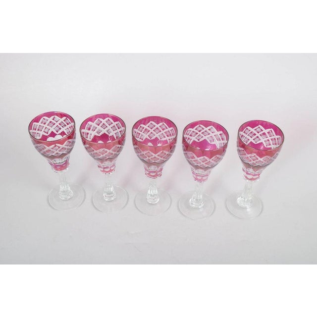 Set of five Bohemian wine glasses. Pink crystal glasses with cut and etched decoration in the classic Bohemian style. The...