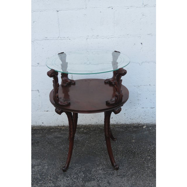 This elegant Side Table is made out of wood, mahogany, veneer, and glass. The Table has a Traditional style and design,...