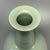 This graceful vase is crafted in classic Chinese Longquan celadon style. It features a flared rim, segmented ribbon neck...