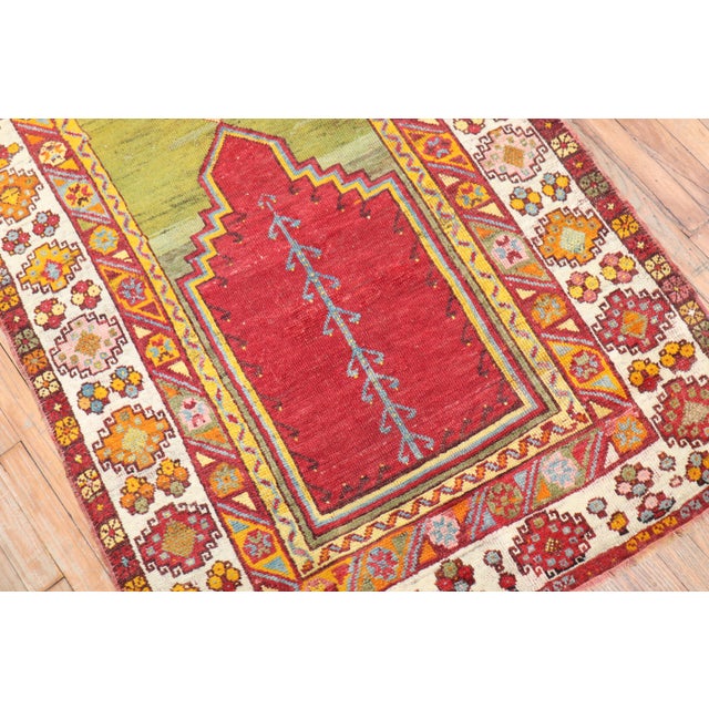 Mid 20th century colorful Turkish Melas rug in bright colors highlighted by a mihrab prayer niche design Measures: 3'6" x...