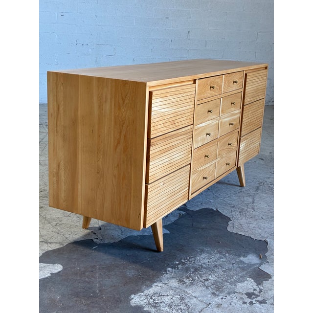 Vintage 9-drawer lowboy dresser featuring newly restored blonde wood, tapered legs, lovely drawer details and brass pulls....