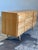 Vintage 9-drawer lowboy dresser featuring newly restored blonde wood, tapered legs, lovely drawer details and brass pulls....