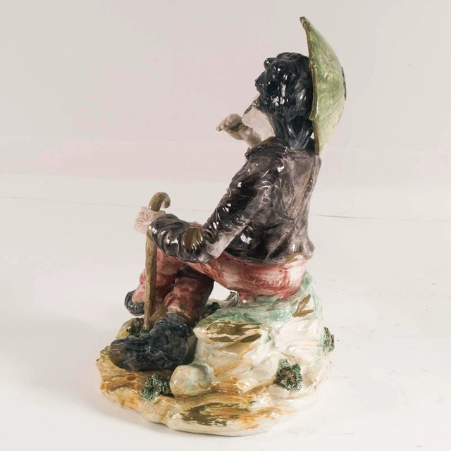 Statue in ceramics; Bassano porcelain early 1900s featuring boy with umbrella. This piece has an attribution mark, I am...