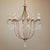 The Crystal Lights Gold Large Chandelier drips with crystal beads that swag between wrought iron curls in a gold leaf...