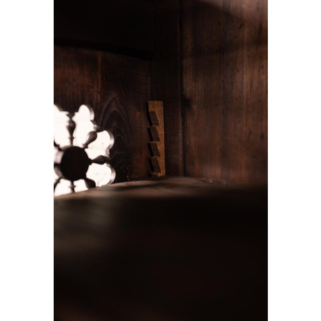 This antique Breton cabinet showcases intricate carved details, decorative panels, and beautifully twisted barley twist...