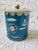 A red, white and blue nautical ship metal tin. There is some wear and rust. I think it's still darling! It looks to be...
