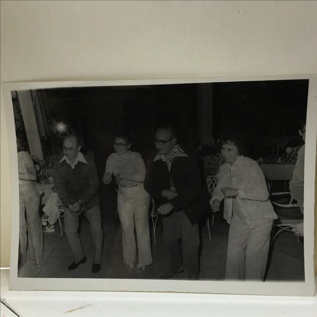 Vintage 1960s photograph of twin brothers on a cruise. Minor wear. These two couples know how to play along!