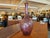 Add a touch of vintage elegance and organic warmth to your space with this striking hand-blown glass vase. Crafted in a...