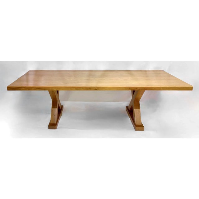 Large custom X-brace leg walnut dining table. Two large stout X-brace leg supports on raised platforms. Designed and...