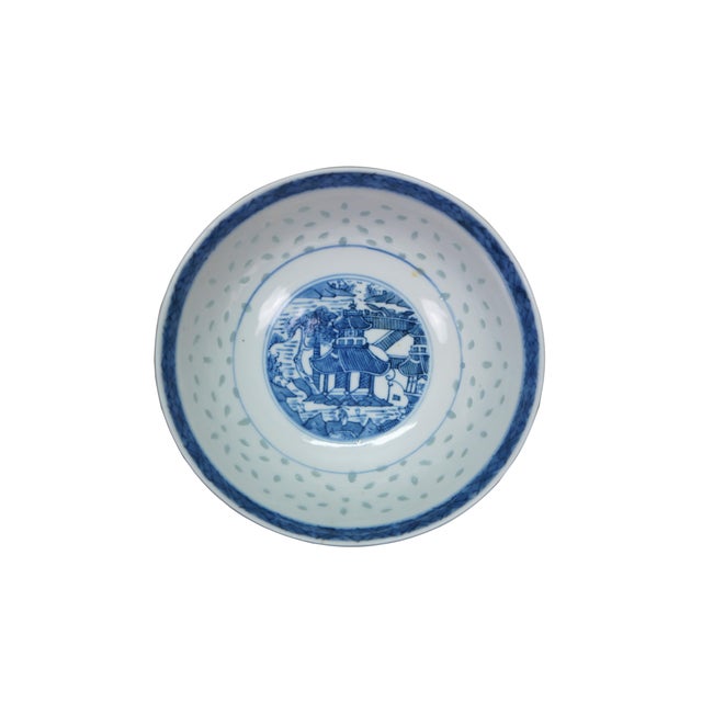Chinese porcelain dishes feature a traditional blue and white design with a "rice grain" or "rice eye" translucent...