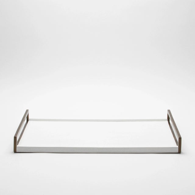 This elegant rectangular tray by R&Y Augousti is a stunning display of luxurious craftsmanship. With its sleek white...