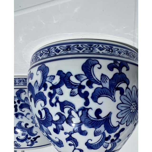 These are vintage-style Oriental Furniture porcelain fishbowl planters featuring a blue and white floral design. The bowls...