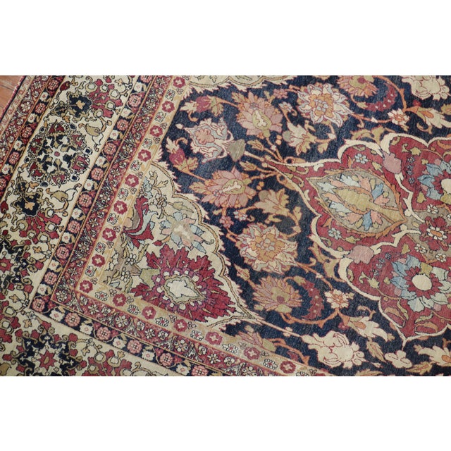 Phenomenal early 20th century antique Persian Kerman rug with a large scale all over design on a navy ground. Sparkling...