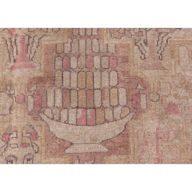 An early 20th century Persian Kirman rug, the camel field with a garden design of subtle flowering shrubs and trees...