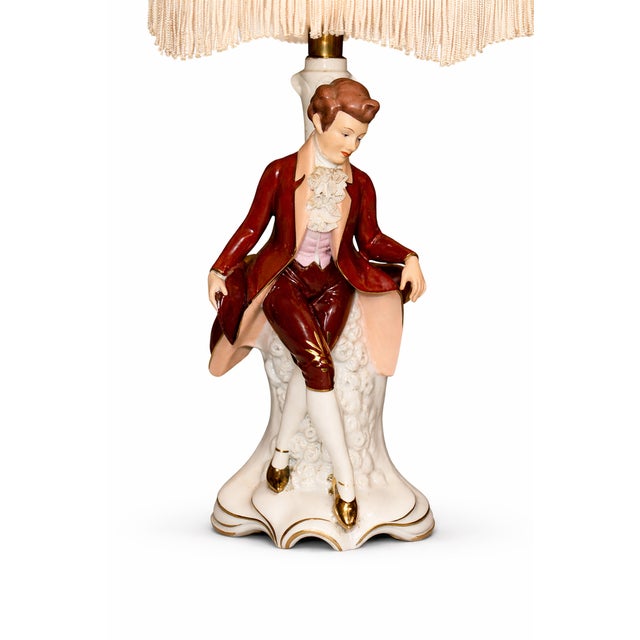 Porcelain table lamp with rococo figure | dresden style | model 5368bl offered is an exceptional table lamp in the classic...