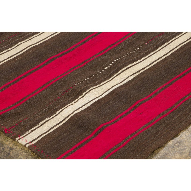 Handwoven in pure wool and originating circa 1950-1959, this 6x8 vintage Turkish Chaput kilim rug joins Rug & Kilim’s...