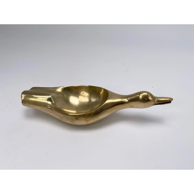 This item is a sculpture, an ashtray or vide poche in brass. In a gold color , it has been made in France circa 1970, ans...