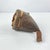 This pillow from Ethiopia is crafted from supple leather, carefully stitched and shaped into a practical yet elegant form....
