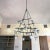 3 Tier wrought iron chandelier with alabaster cups in the style of Villa Kerylos in France.