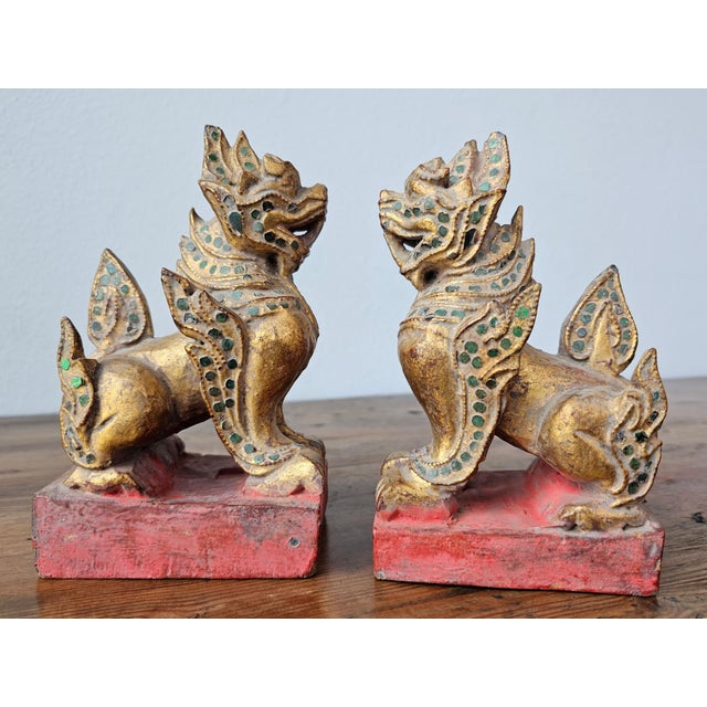 A near pair of antique Southeast Asian Burmese jeweled parcel gilt wooden temple guardian figures. circa 1900 Hand carved...