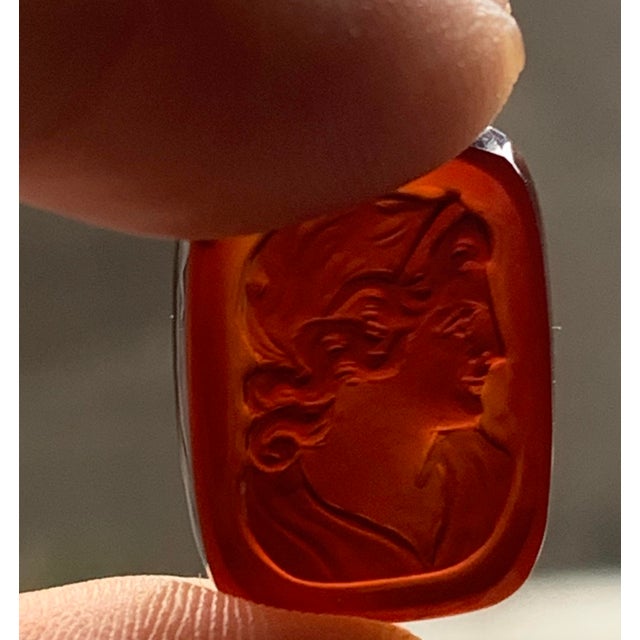Beautiful pair of vintage carnelian intaglio gemstones featuring a classical female profile. Each rectangular stone is...