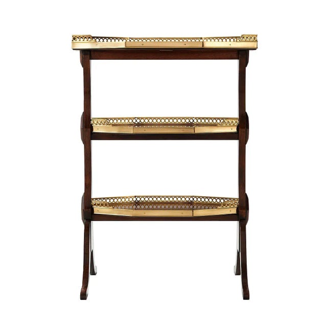 A French Directoire style three-tier lamp table, each elongated octagonal tier with a three quarter pierced brass gallery,...