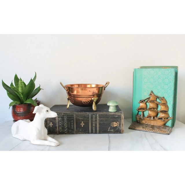 Small copper and brass footed colander or strainer with handles. Could serve as a decorative bowl or planter. No makers...