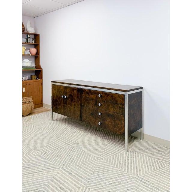 This extraordinary Tomlinson mid-century modern burlwood credenza is a rare and highly collectible vintage statement...