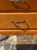 These early 20th century French Provincial fruitwood nightstands feature a medium wood tone with a gold hardware. A lovely...
