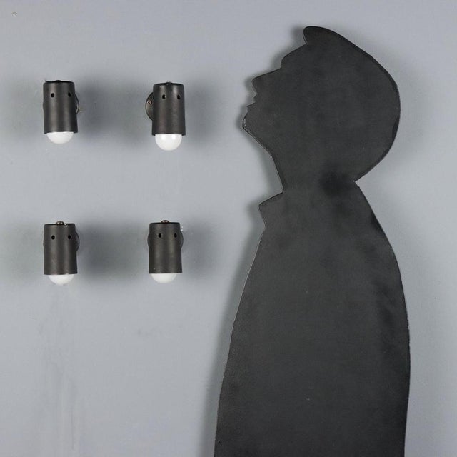 Set of four 1960s wall lamps characterized by a functional and understated design. Each lamp is made of enameled metal,...