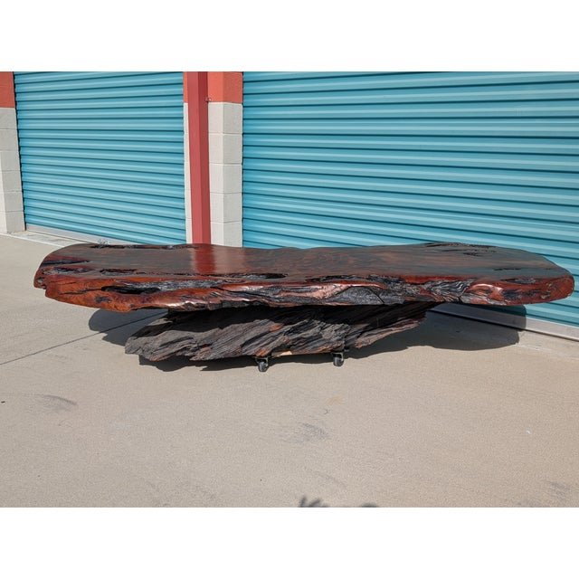 This truly one-of-a-kind monumental live edge coffee table features an impressive 97-inch solid redwood slab, beautifully...
