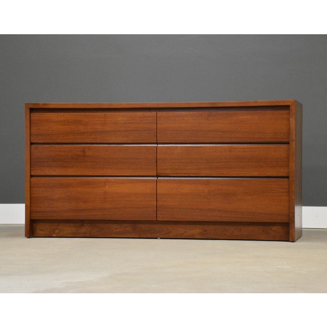 A mid century modern teak six drawer dresser with a plinth base and sculpted drawer pulls. Made in Denmark. Circa 1960’s....