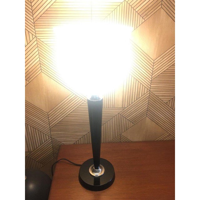 Mazda-style lamp with an art deco look, made of black lacquered wood and white opaline glass. This piece is designed in...