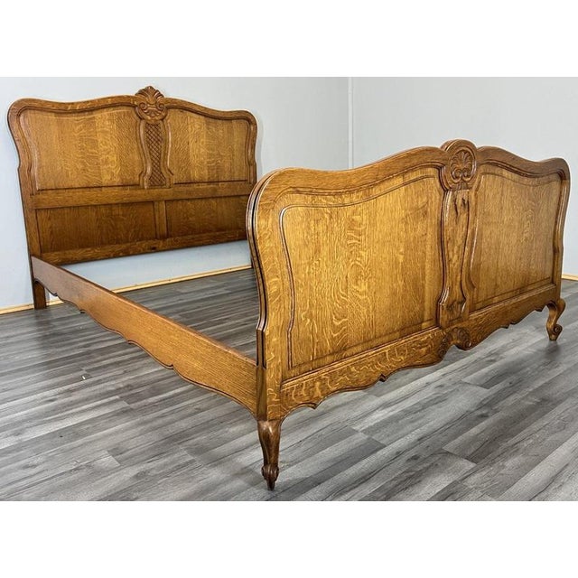 This Vintage French Louis double bed frame presents elegant proportions and refined carved detailing, offering classic...