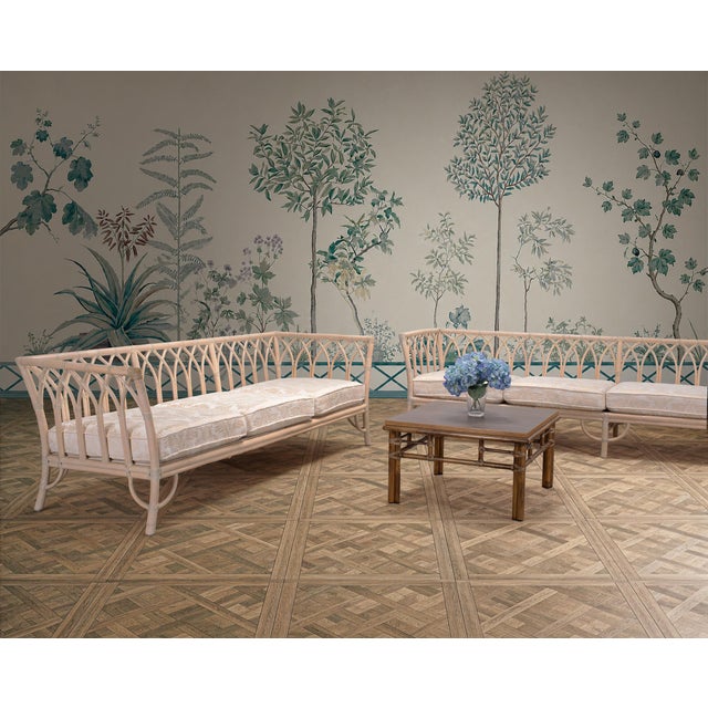 A gorgeous pair of sculptural bleached rattan organic modern cathedral sofas made by McGuire, San Francisco, CA. The grand...