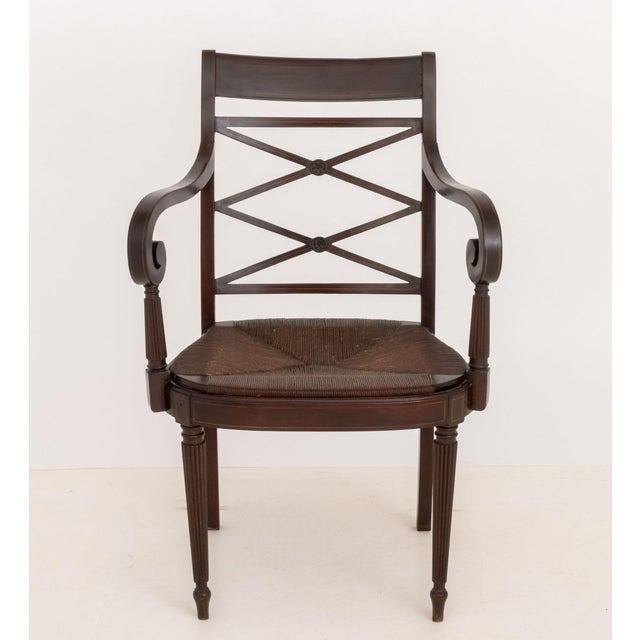 Regency Style Mahogany Arm Chair, with string inlay to the scroll arms, rush seat, and four fluted tapered legs. 36.5" H x...