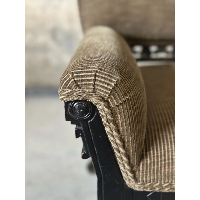 Sophisticated Dutch Colonial inspired Eastlake period armchair. Carved rich ebony wood is paired with new corduroy...